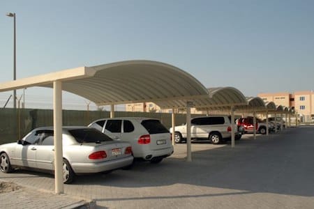 K Span car parking shades UAE - self-supporting arched metal roof parking structure without internal columns