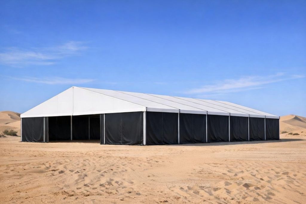 Black curtain wall tent with white roof in desert by Mahraj Industries - top tent supplier Dubai
