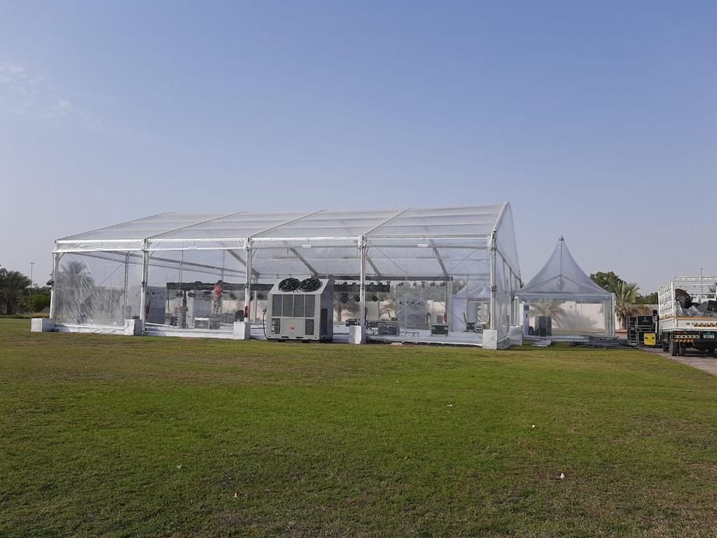 Clear roof tent side view with event setup equipment supplied by Mahraj Industries UAE
